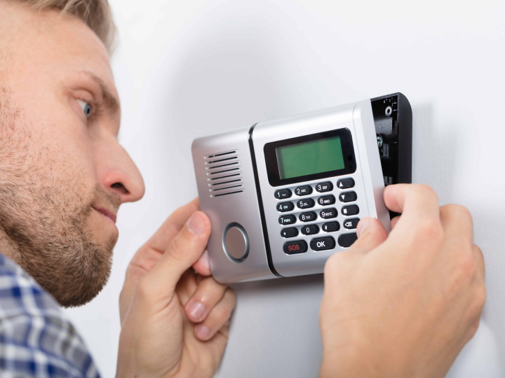 Repairman Installing Security System