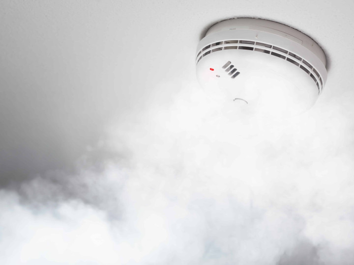 smoke detector of fire alarm in action, white background
