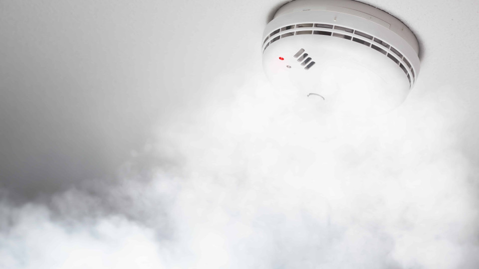 smoke detector of fire alarm in action, white background