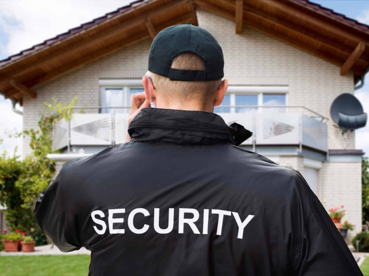 Close-up Of Male Security Guard Wearing Black Jacket